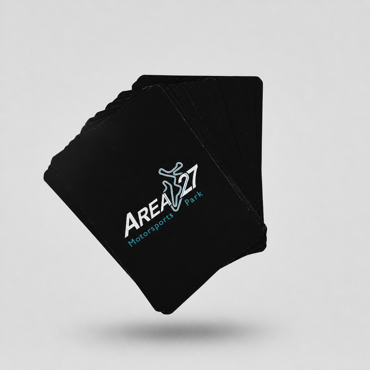 Area 27 playing cards on a light grey studio background