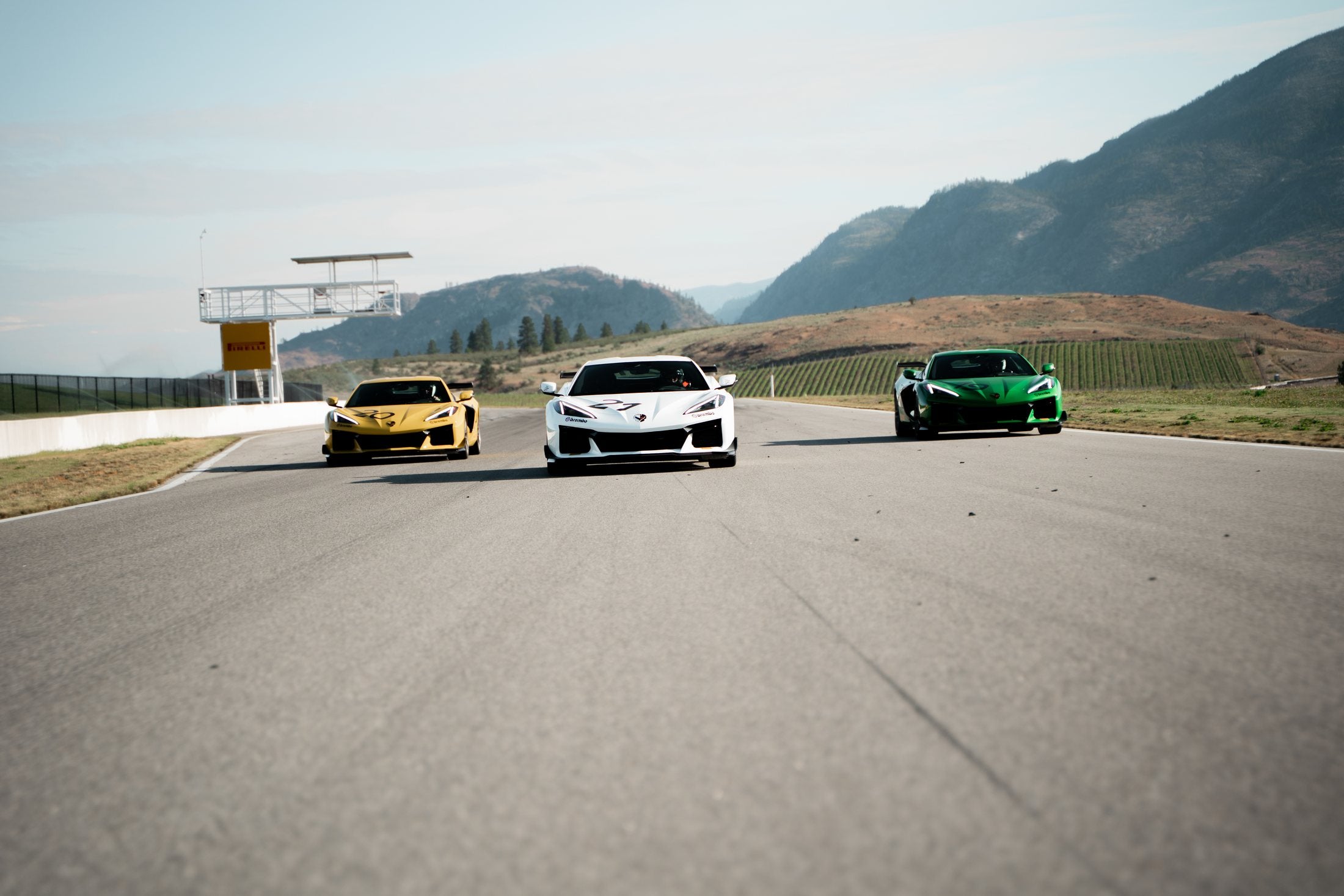 Three Chevrolet Corvette performance cars driving together on the Area 27 circuit